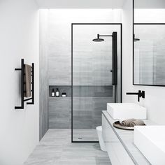 a white bathroom with two sinks and mirrors