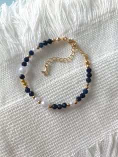 FOR OTHER DAINTY BEADED BRACELETS: https://www.etsy.com/ca/shop/ArtiChouXCanada?ref=seller-platform-mcnav%C2%A7ion_id§ion_id=46088511 Bracelet Length: 13-18cm (5.1-7 inches) with a 14k gold filled extender. But if you require a different size or prefer a personalized touch, please don't hesitate to get in touch. This bracelet features beautiful deep blue colors: blue sapphire gemstones, faux pearls and gold plated seed beads.  Thread may be visible since it is a handmade product   SIZING  Wrap a Blue And Gold Beaded Bracelets, Navy Blue Bracelet, Blue And Gold Bracelets, Blue Bracelet Beads, Beaded Bracelets Blue, Blue Bead Bracelet, Pearls Bracelet, Blue Beaded Bracelets, Handmade Jewelry Bracelets