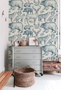 the wallpaper in this room is decorated with blue and white animal designs on it