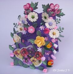 a purple bag filled with lots of different types of flowers on top of each other