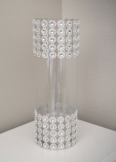 a clear vase sitting on top of a white table