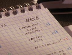 two notebooks sitting next to each other on top of a desk covered in writing