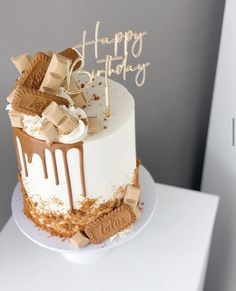 a birthday cake with chocolate and marshmallows on the top that says happy birthday