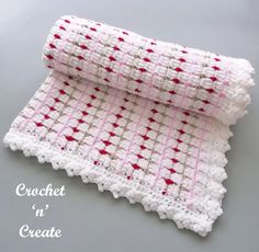 a crocheted table cloth with red and white stars on it, sitting on top of a gray surface