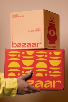 a person holding two boxes on top of each other