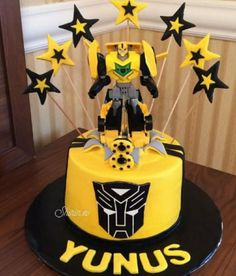 a yellow and black cake with stars on it