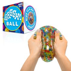 a person holding a gummy ball in front of a box of gummy balls