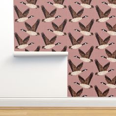 a pink wallpaper with birds flying in the sky and on it's side