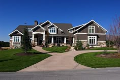 a large house with lots of windows and landscaping