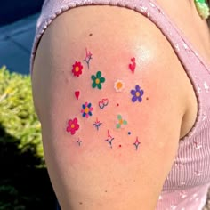 a woman with flowers and hearts on her arm