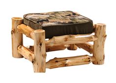 a log chair and footstool made out of logs with an animal on it