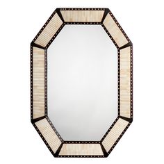 a mirror that is sitting on top of a white surface with brown trimmings