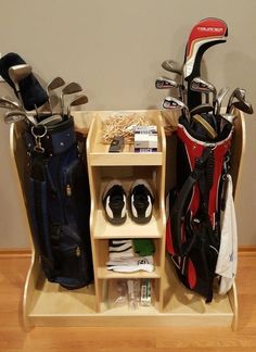 two shelves with golf clubs, shoes and other items in them on a wooden floor