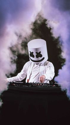 a person wearing a white mask and headphones on top of a dj's turntable