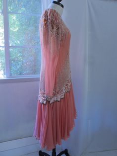 "80s vintage Lillie Rubin original. Excellent condition. Silk chiffon with rayon lining. Long back zipper. White pearl beads, silver bugle beads, silver seed beads, pink sequins, Size 8. Measurements, laying flat: 15.5\" across shoulders 18\" underarm to underarm (36\" bust) 15\" across waist area 23.5\" sleeve length 37\" length in the front; 44.5\" length in the back Hits at the knee in the front and mid-calf in the back." Vintage Embellished Fitted Flapper Dress, Vintage Fitted Embellished Flapper Dress, Vintage Embellished Flapper Dress For Cocktail, Vintage Cocktail Flapper Dress With Beaded Fringe, Vintage Beaded Dress For Vintage Events, Beaded Fitted Flapper Dress For Wedding, Vintage Silk Dress With Beading, Vintage Beaded Silk Dress, Vintage Cocktail Dresses With Beaded Fringe