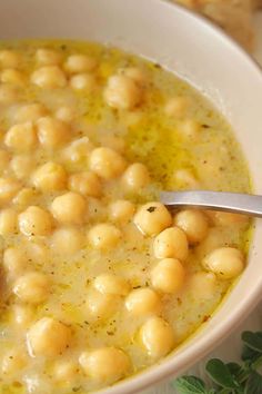 a white bowl filled with chickpeas and garnished with parsley