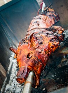 a close up of a meat on a grill with words written in spanish and english