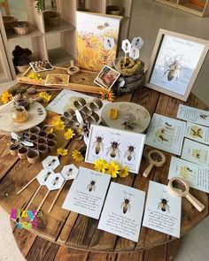 a table topped with lots of cards and pictures on top of a wooden round table