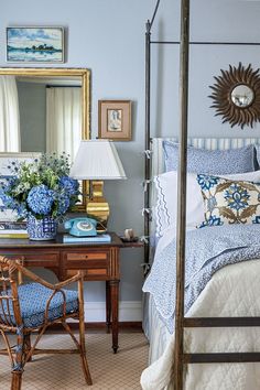 a bedroom with blue and white decor on the walls