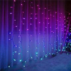 purple and blue lights are hanging from the curtain