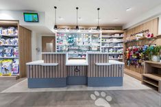 the inside of a store with shelves, counters and dog paw prints on the floor