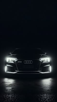 an audi car in the dark with headlights on