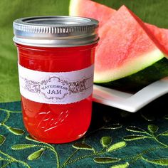 a jar of watermelon jam next to slices of watermelon