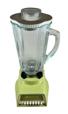 a yellow blender sitting on top of a white counter next to a brown lid