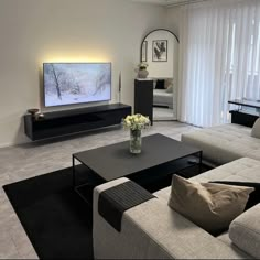 a living room filled with furniture and a flat screen tv on top of a wall