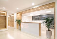 an empty office lobby with plants in the corner