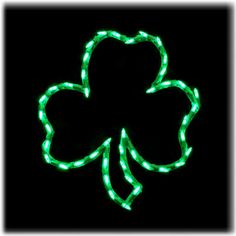 a shamrock shaped light up sign on a black background