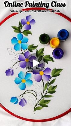 a painting class with blue and purple flowers painted on the back of a white plate