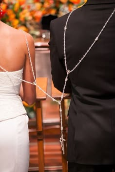 the back of a bride's dress as she walks down the aisle to her groom