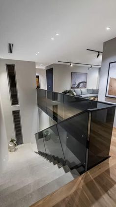 an open concept living room with stairs leading up to the second floor