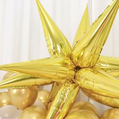 gold balloons are arranged in the shape of a star