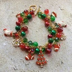 This Christmas charm bracelet is approx. 8 inches long and surrounded by green and red glass beads and holiday charms. #15 Merry And Bright Christmas Bracelets, Emily In Paris Fashion, Holiday Bracelets, Bracelet Christmas, Jewelry Holiday, Christmas Necklace, Christmas Bracelet, Jewelry Christmas, Christmas Charms