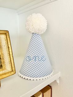 The Embroidered One Birthday Hat is the perfect accessory for a first birthday, photoshoot, or both!  It features "one" in a sweet cursive print embroidered on the fabric of your choice, rick rack, pleated ruffle, or white dot trim, and a fluffy handmade pom pom to top it off! It also has an elastic band that goes under the chin to keep it securely on your little one's head.  Hat measures approximately 8 inches tall (from the top of the Pom Pom to the bottom of the trim) by 5 inches wide (at the base)  **This hat can be made in any fabric or pom pom color! It can also be made in TWO instead of one! Please message me along with your order, if there is another fabric or color you would like! First Birthday Party Hat, Embroidered Birthday Hat, Birthday Corner, Disney Stroller Tags, Baby Birthday Hat, Disney Stroller, First Birthday Photoshoot, Care Bear Birthday, First Birthday Hats