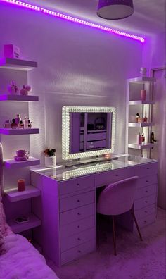 a bedroom with purple lighting and a white desk in front of a mirror on the wall