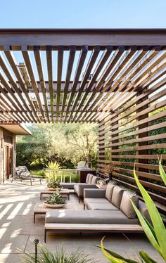 an outdoor living area with couches and tables