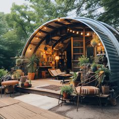 an outdoor living area with lots of plants and furniture