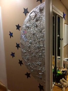 the moon is made out of tin foil and stars on it's back wall