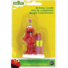 the sesame street birthday candle holder is red and has a sesame character on it's head