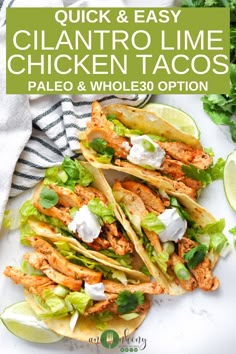 three chicken tacos with lettuce and sour cream on top, next to lime wedges