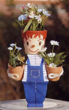 there is a doll with flowers in his hands