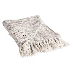 a white throw blanket with fringes on the bottom and one piece of it folded up