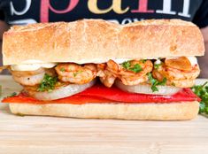 there is a sandwich with shrimp and peppers on it