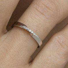 a woman's hand with a diamond ring on it