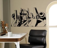 a black and white drawing on the wall next to a chair in front of a desk