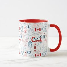 a red and white coffee mug with the word canada printed on it, sitting on a marble surface