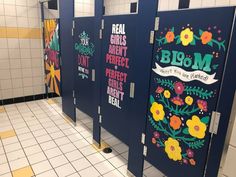 the restroom is decorated with colorful flowers and sayings